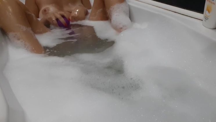 Hot feet in bath. Play with toy in bath and touching body
